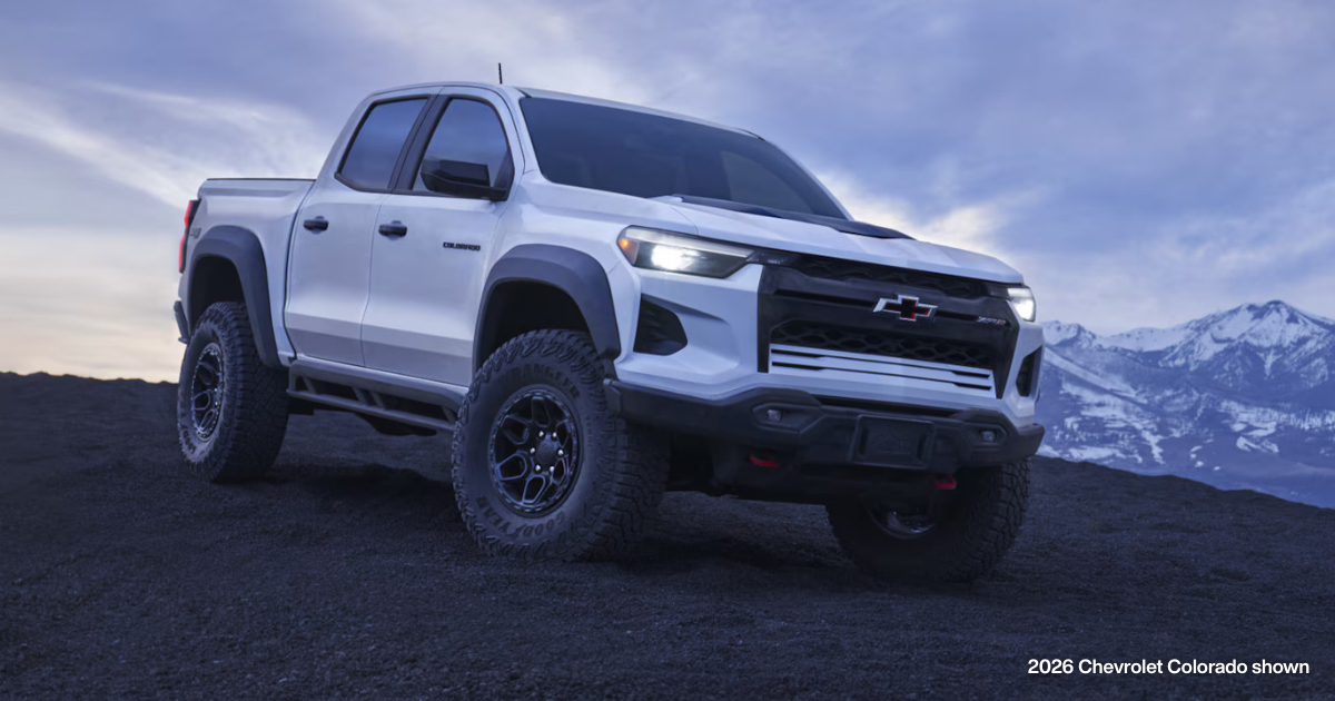 a 2026 Chevy Colorado on a mountainside with white mountain tops in the background on the right