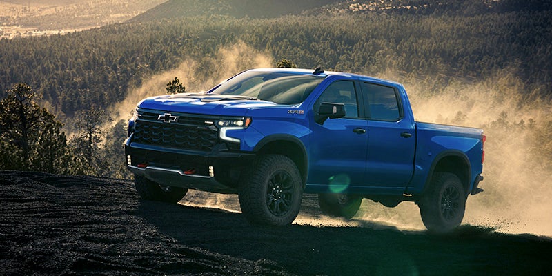 2025 Chevrolet Silverado 1500 driving up a mountain