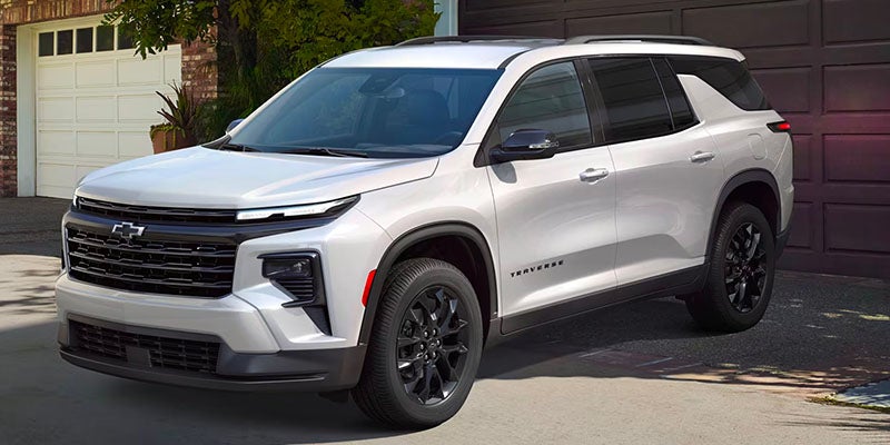 A white Chevrolet Traverse in a driveway
